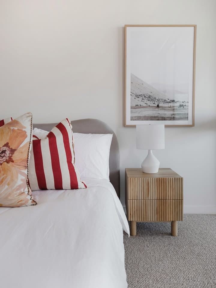 A recent Cliff Hanger install. Framed artwork above a striped, upholstered bedhead in a Brisbane bedroom.