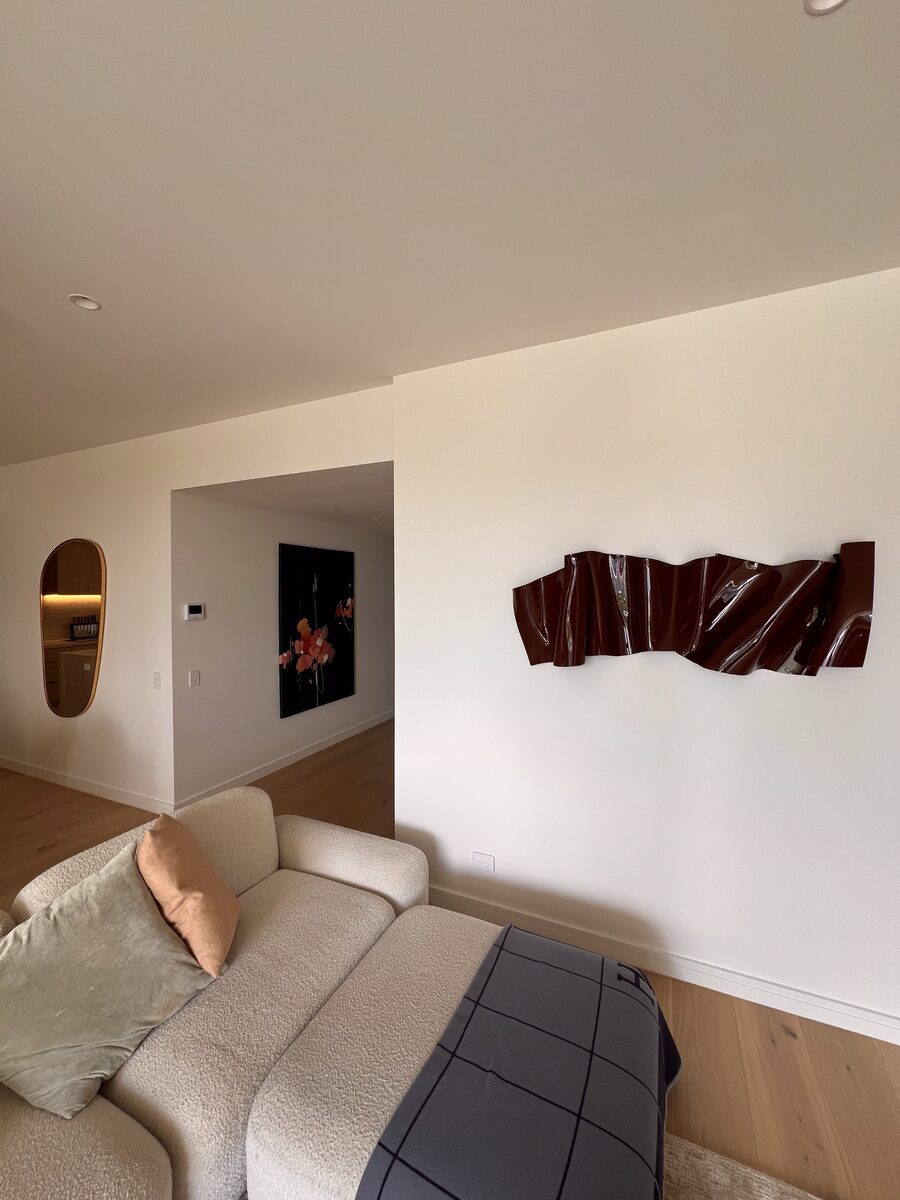 Sculptural wall piece installed in a coastal home with mounting set into solid block.