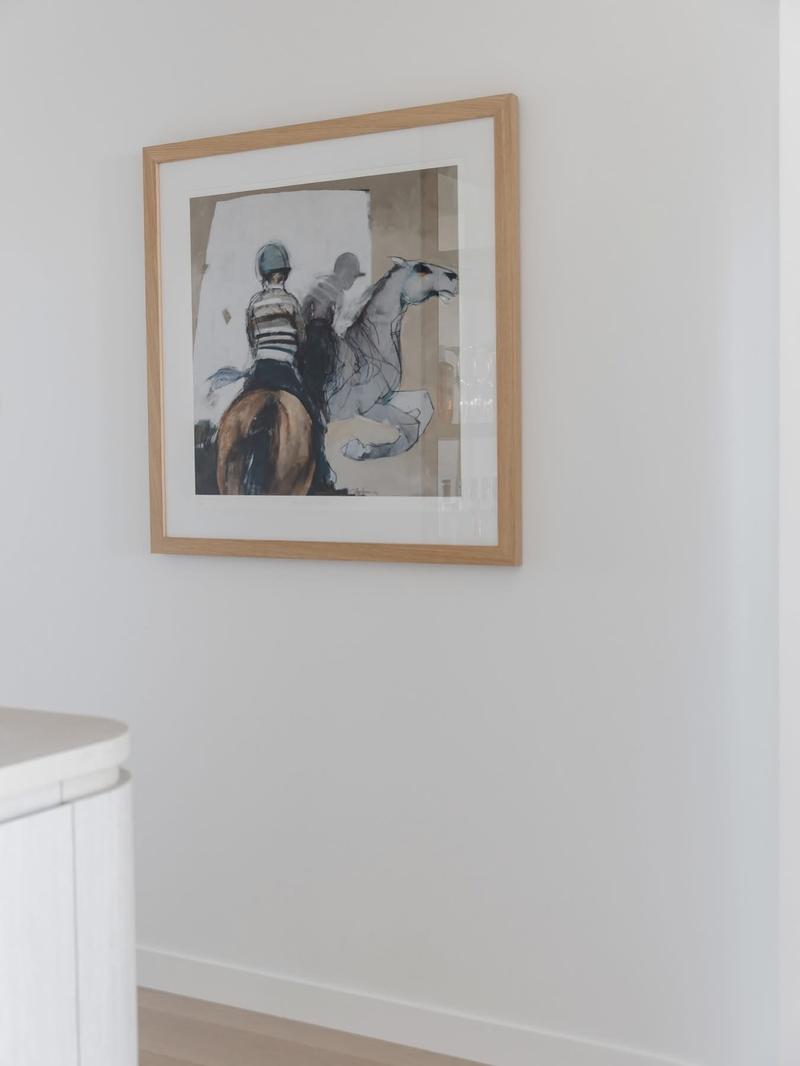 Framed artwork installed, sunlit kitchen. Cliff Hanger Installations.