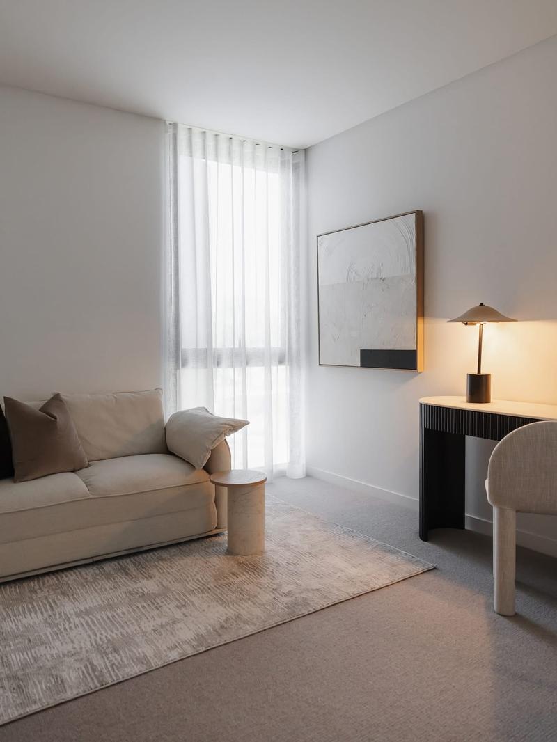 Large artwork hung in a Brisbane living room with sheer curtains catching afternoon light.