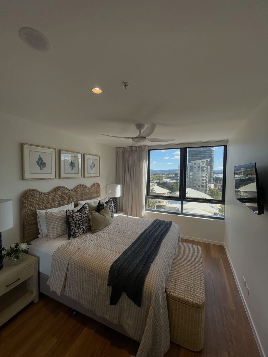 TV installed cleanly above a built-in joinery unit, cables fully concealed.